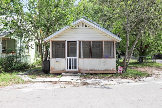 view of front facade with a sunroom