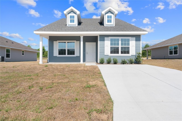 view of front of property featuring central AC, a porch, and a front yard