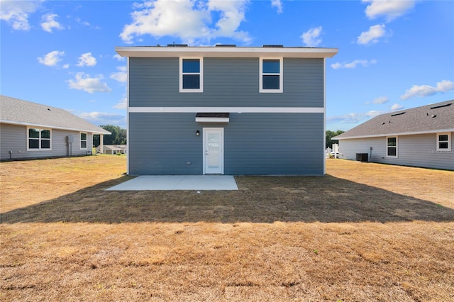 back of property featuring a yard, cooling unit, and a patio area