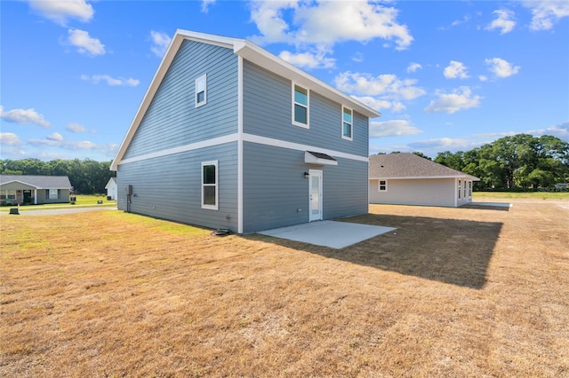 rear view of property with a patio area and a yard