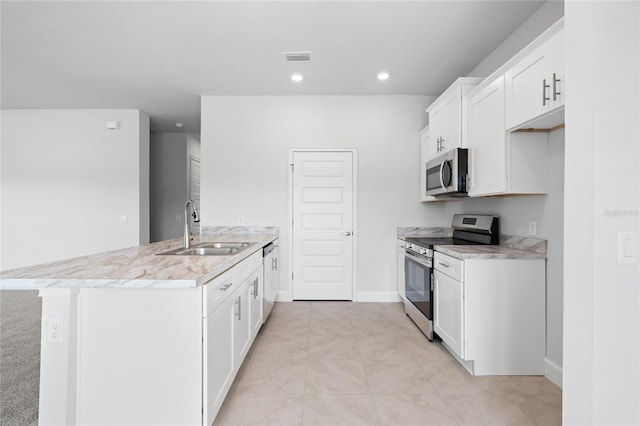 kitchen featuring white cabinetry, sink, stainless steel appliances, light stone counters, and light tile patterned floors