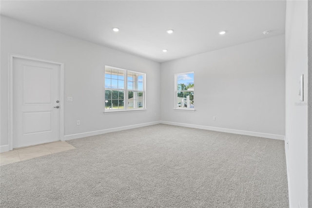 unfurnished room featuring light carpet