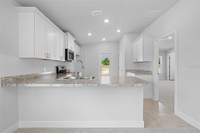 kitchen with kitchen peninsula, stainless steel appliances, white cabinets, and sink