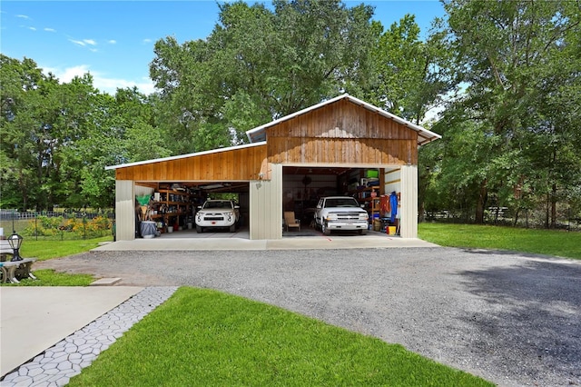 garage featuring a yard and a carport