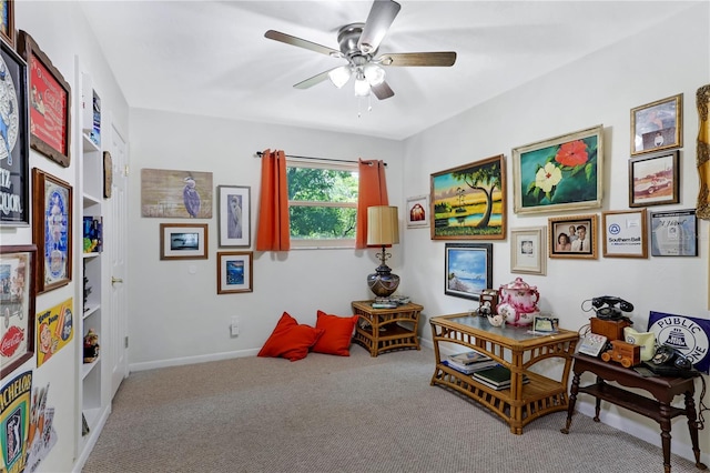 sitting room featuring ceiling fan and carpet floors