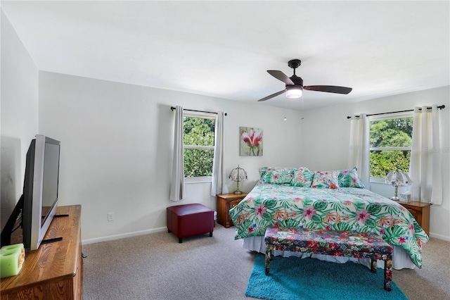 bedroom featuring carpet flooring, multiple windows, and ceiling fan