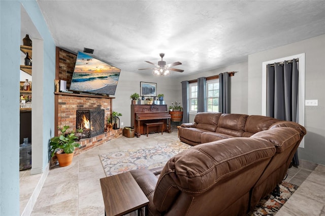 living room featuring a fireplace and ceiling fan