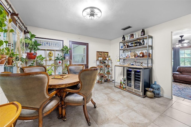 dining space featuring indoor bar and beverage cooler