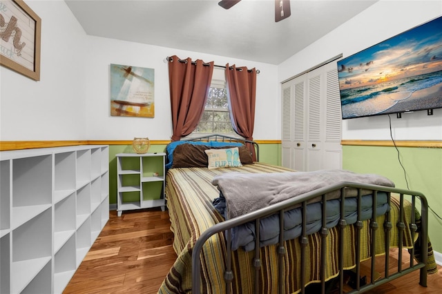 bedroom with wood-type flooring, a closet, and ceiling fan