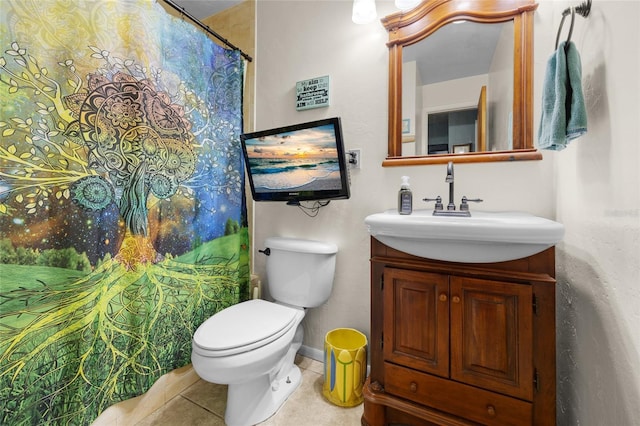 bathroom with tile patterned floors, vanity, and toilet