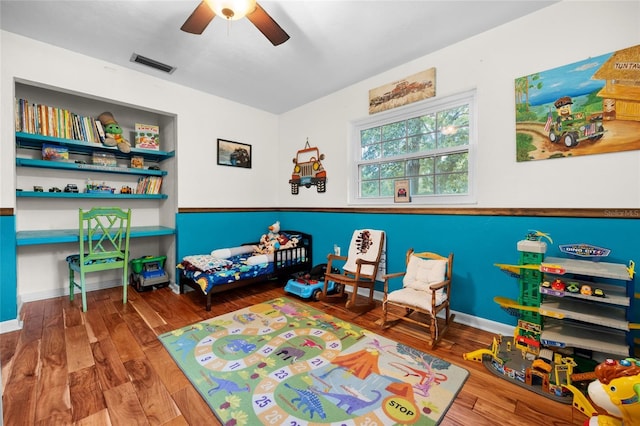 bedroom with ceiling fan and wood-type flooring