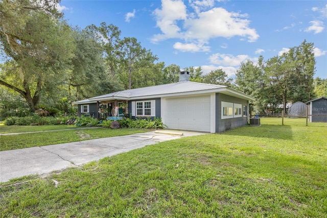 ranch-style home featuring a garage, a front yard, central air condition unit, and a porch