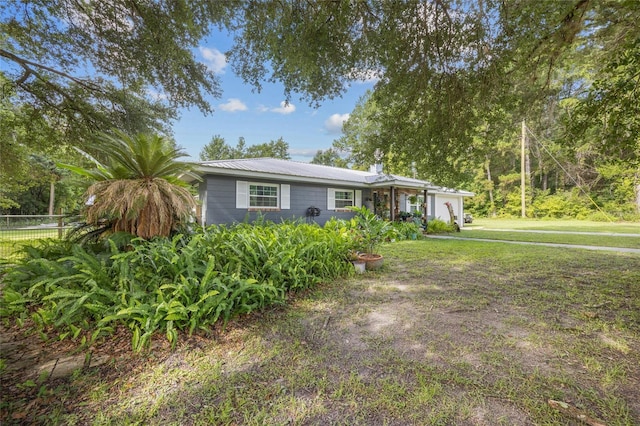 ranch-style house featuring a garage and a front yard