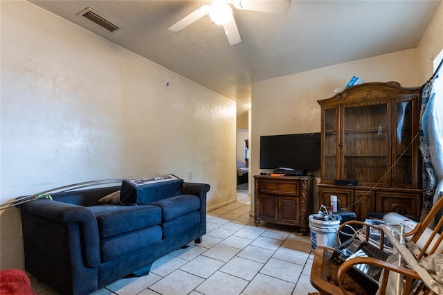 tiled living room with ceiling fan