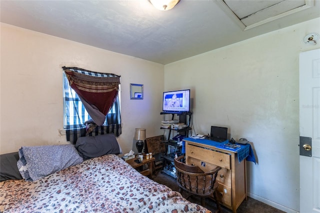 bedroom with dark colored carpet