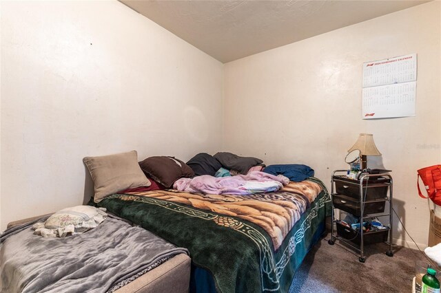 carpeted bedroom featuring lofted ceiling