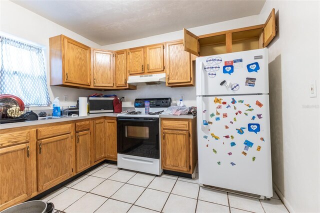 kitchen with light tile patterned floors and white appliances