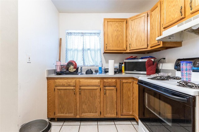 kitchen with white electric range and light tile patterned floors