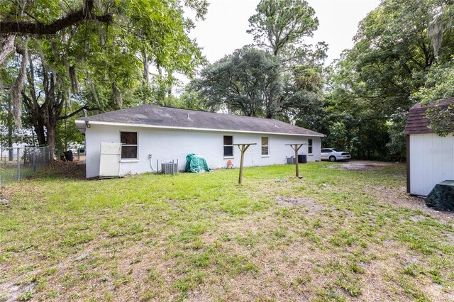 rear view of property with a yard