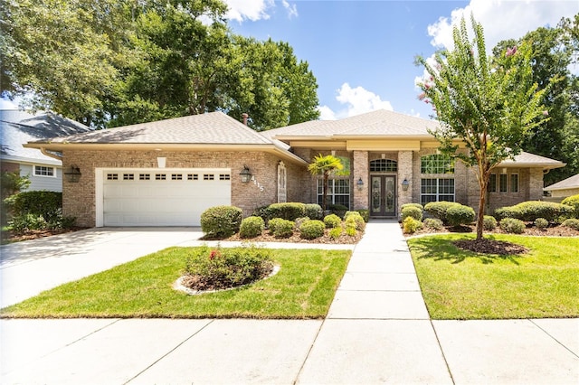 view of front of house featuring a front lawn, a garage, and french doors