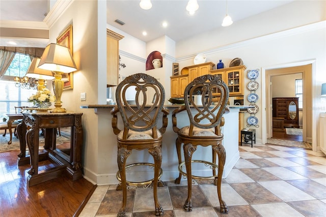 dining room with plenty of natural light and ornamental molding