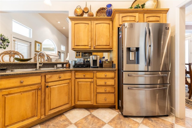 kitchen featuring stainless steel fridge with ice dispenser and sink