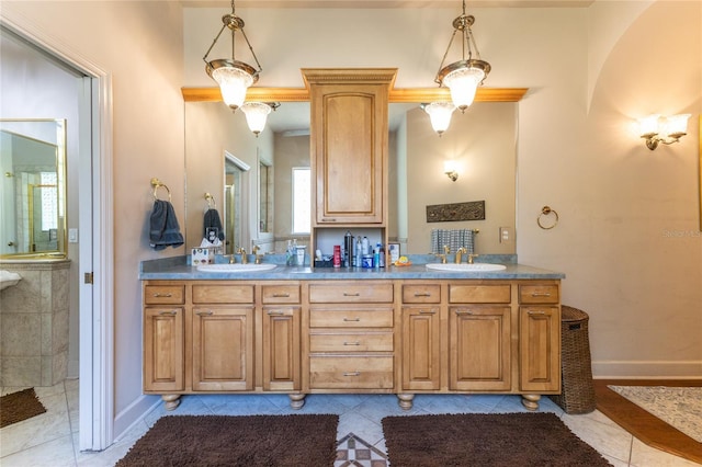 bathroom featuring tile patterned floors, vanity, and walk in shower