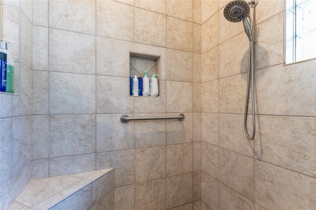 bathroom with a tile shower