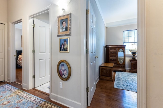 hallway with hardwood / wood-style floors