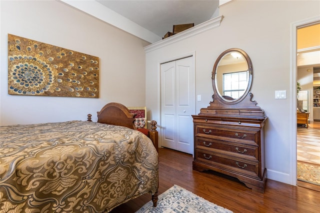 bedroom featuring dark hardwood / wood-style flooring and a closet