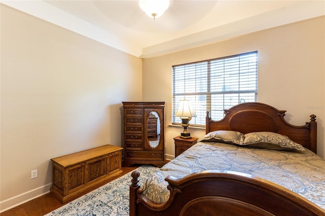 bedroom with ceiling fan and dark hardwood / wood-style floors