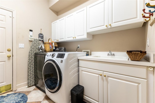 clothes washing area featuring cabinets, washer and clothes dryer, and sink