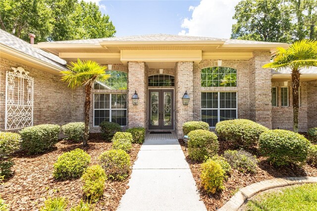 view of exterior entry featuring french doors