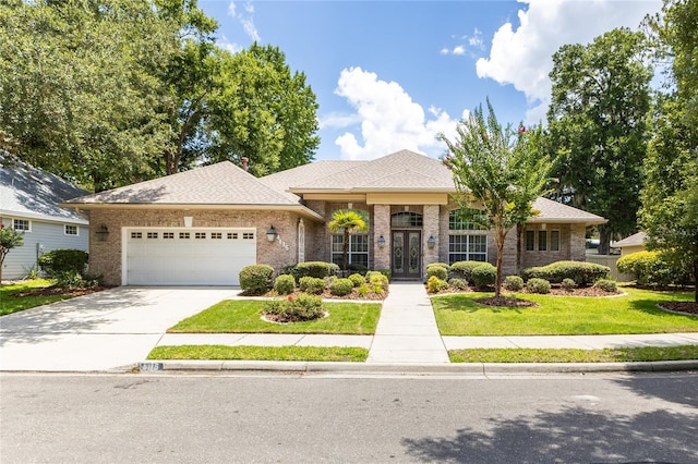 view of front of house with a front yard, french doors, and a garage