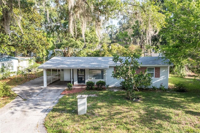 929 SE 9th Pl, Gainesville, FL 32641 - ranch-style house featuring brick siding, a front lawn, a carport, and concrete driveway