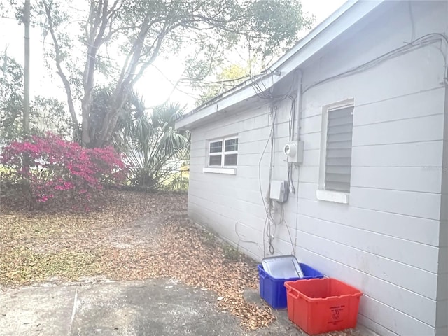 view of side of home featuring fence