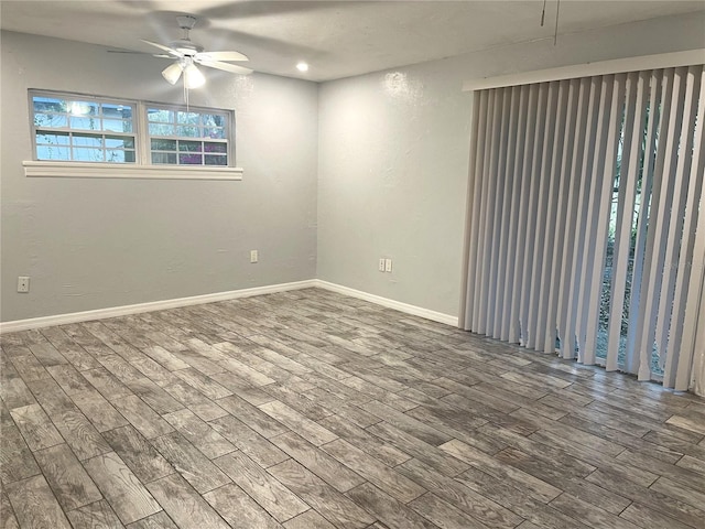 unfurnished room featuring ceiling fan, baseboards, and wood finished floors