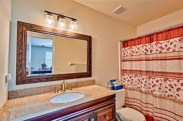 bathroom featuring vanity, a shower with shower curtain, and toilet