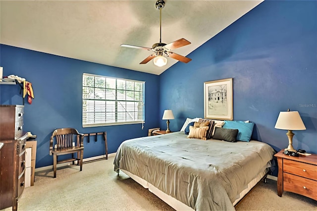 bedroom featuring light colored carpet, vaulted ceiling, and ceiling fan