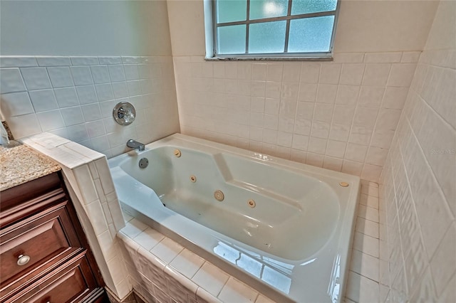 bathroom with vanity and tiled tub