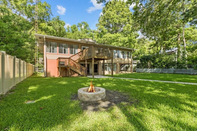 back of house with a sunroom, a deck, and a yard