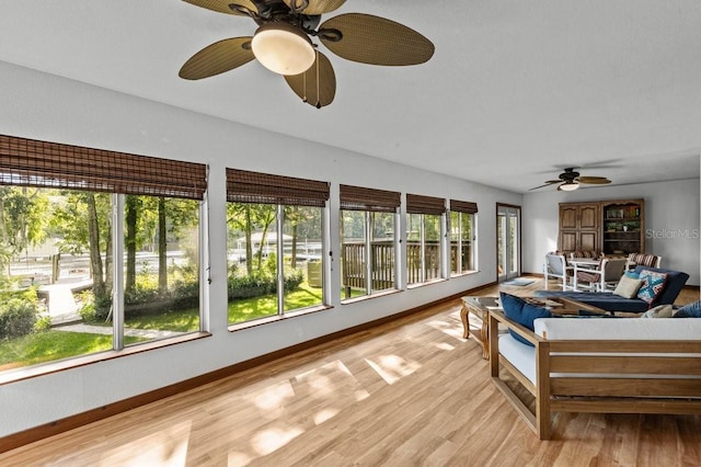 sunroom / solarium with ceiling fan and a wealth of natural light