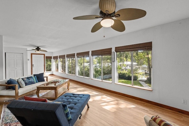 sunroom / solarium featuring ceiling fan