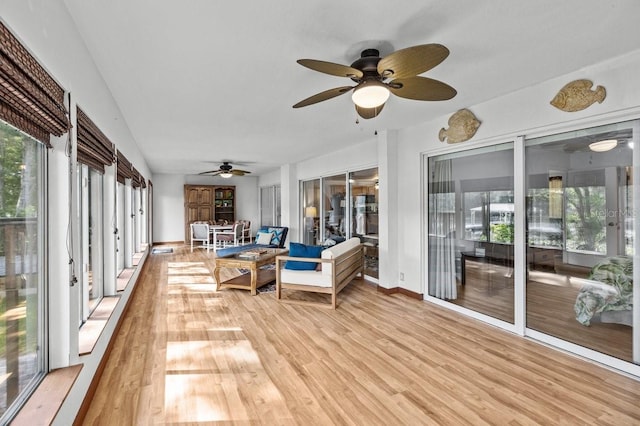 sunroom / solarium featuring a wealth of natural light and ceiling fan