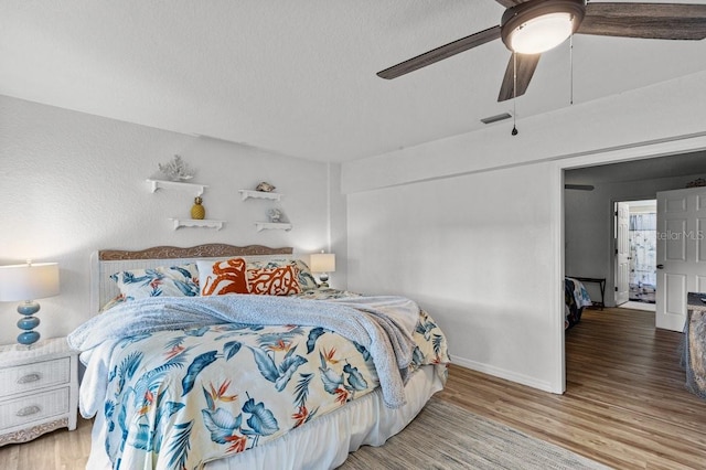 bedroom with wood-type flooring and ceiling fan