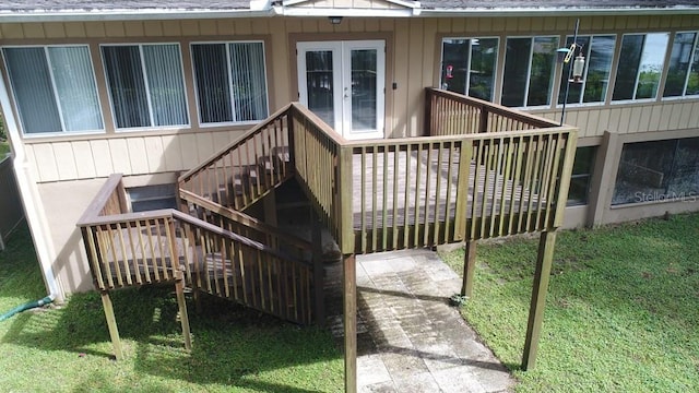 deck with french doors and a yard