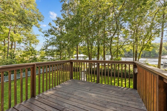 wooden deck featuring a yard and a water view