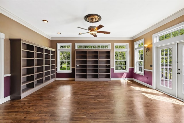 unfurnished living room featuring dark wood-type flooring, crown molding, and french doors