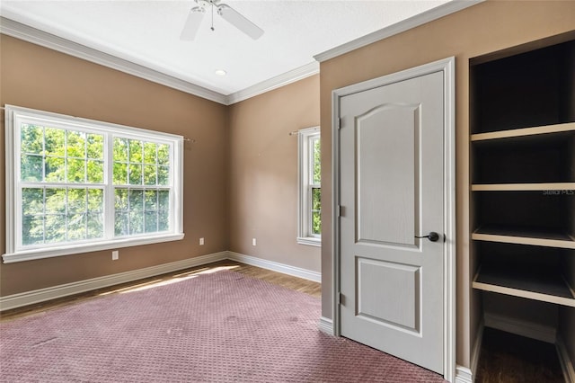 interior space with wood-type flooring, ornamental molding, and ceiling fan