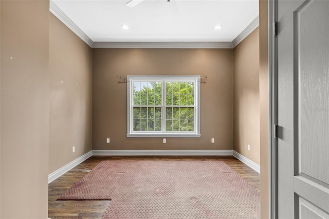 empty room with hardwood / wood-style flooring and ornamental molding